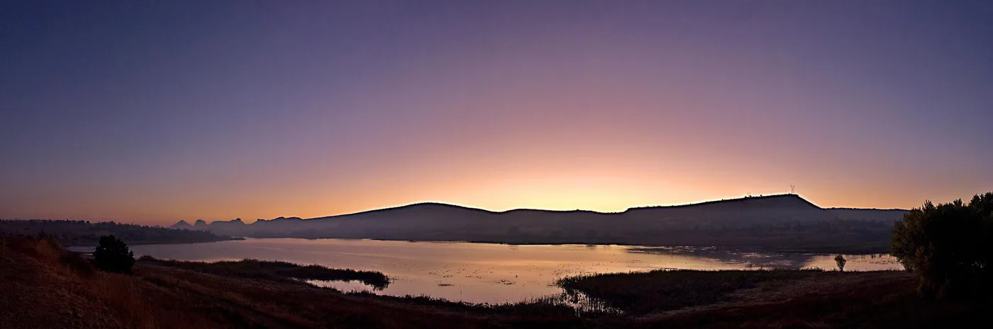 Watson Lake at sunrise with the Granite Dells on the horizon