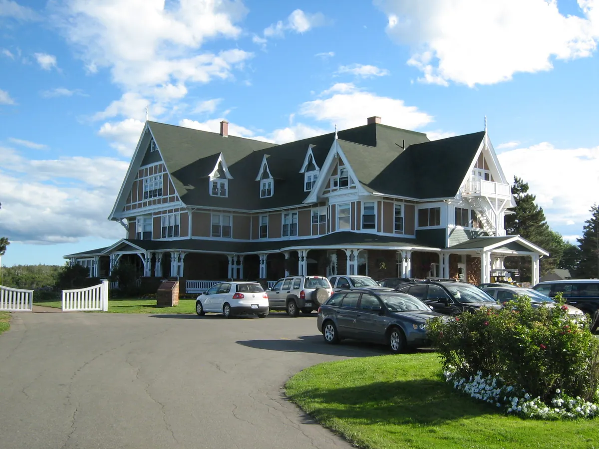 Dalvay-by-the-Sea, a large Tudor-style inn with green trim, gables and a lawn