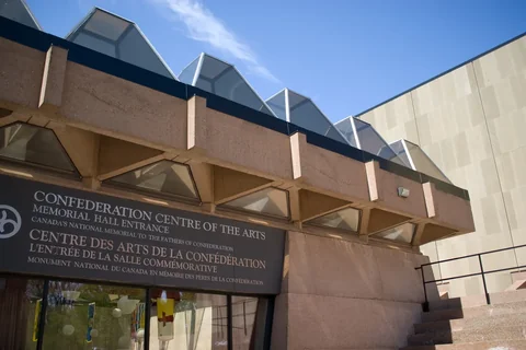 The Confederation Centre of the Arts in Charlottetown, a modern sandstone building with a bilingual name sign