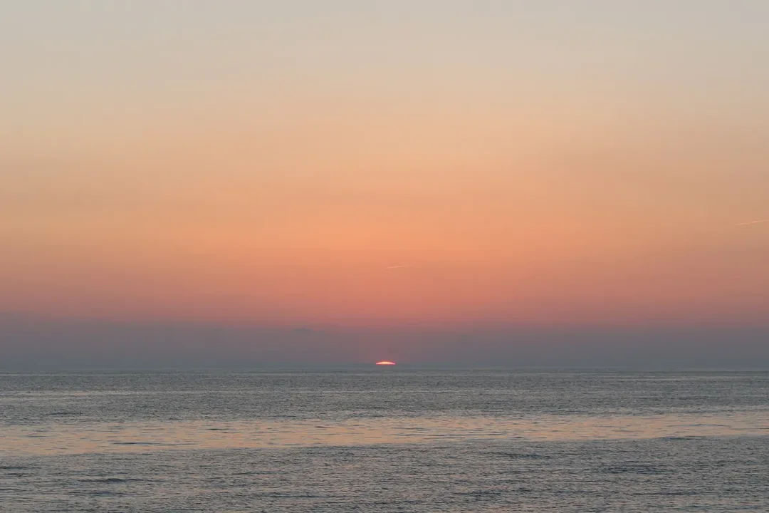 The sun setting over the water at Herring Cove Beach in Provincetown