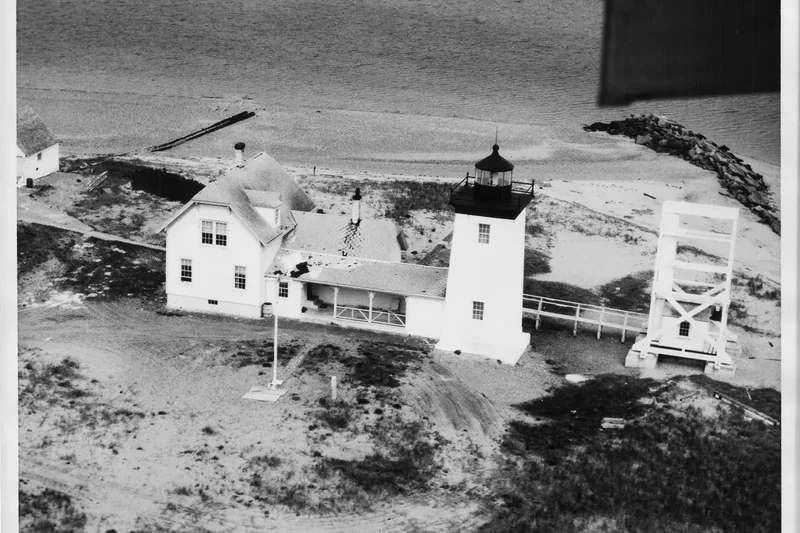 Long Point Lighthouse on the sand at the tip of Provincetown Harbor, in black and white