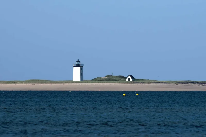 Wood End Lighthouse, a small square tower on the sand beyond the West End