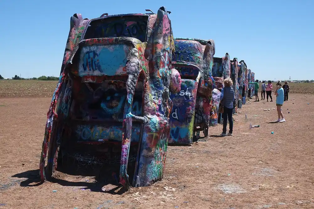 Spray-painted Cadillacs nose-down at Cadillac Ranch