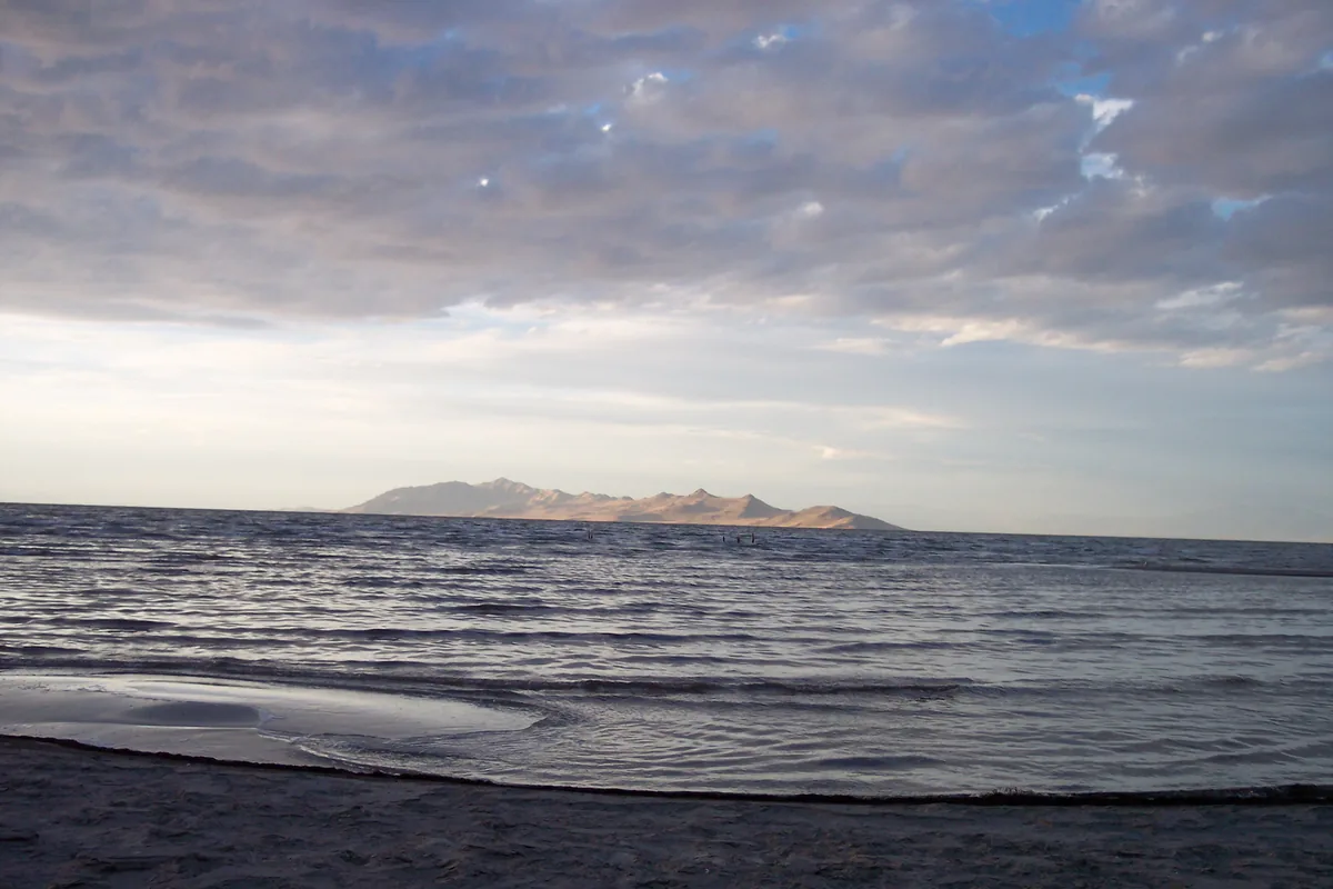 Small waves on the Great Salt Lake at Sunset Beach under a cloudy sky
