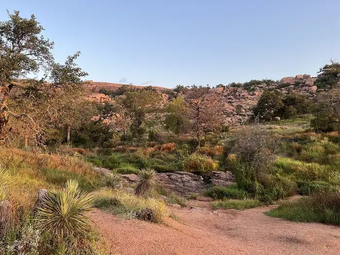 Hiking trail at Enchanted Rock with pink granite in theerslide in Oak Creek Canyon