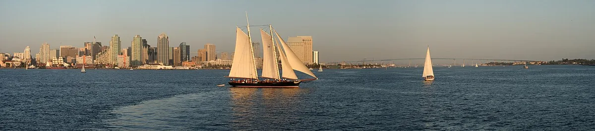 San Diego skyline across the bay with a tall ship sailing past