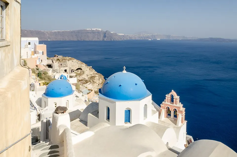 Oia's blue domes above the caldera