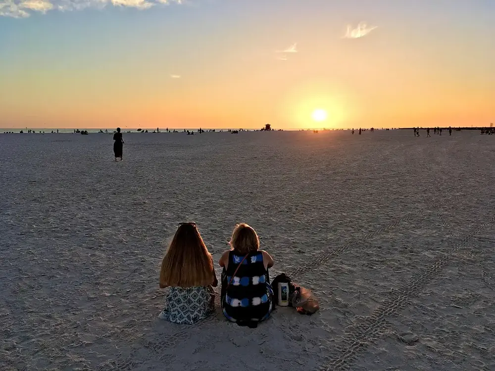 Families enjoying sunset at Siesta Beach on Siesta Key