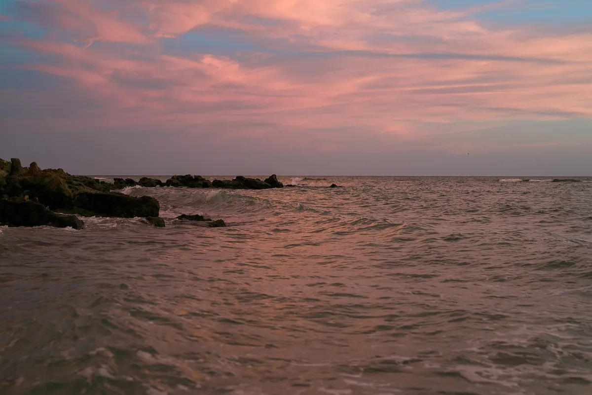 Sunset over the rocky shoreline at Caspersen Beach, Venice