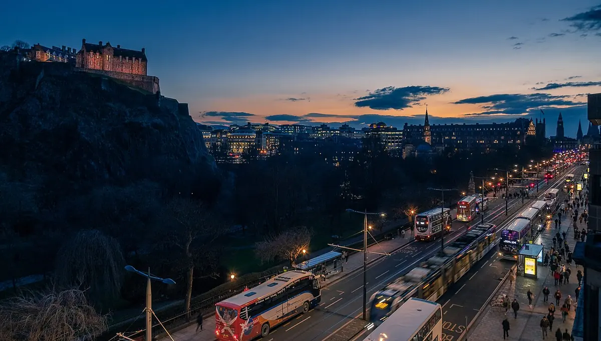 Edinburgh Castle lit up at night above the city