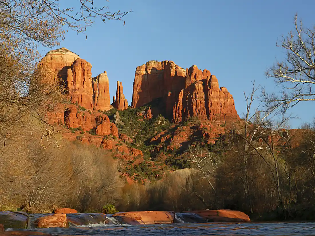 Cathedral Rock's red sandstone spires glowing at sunset in Sedona