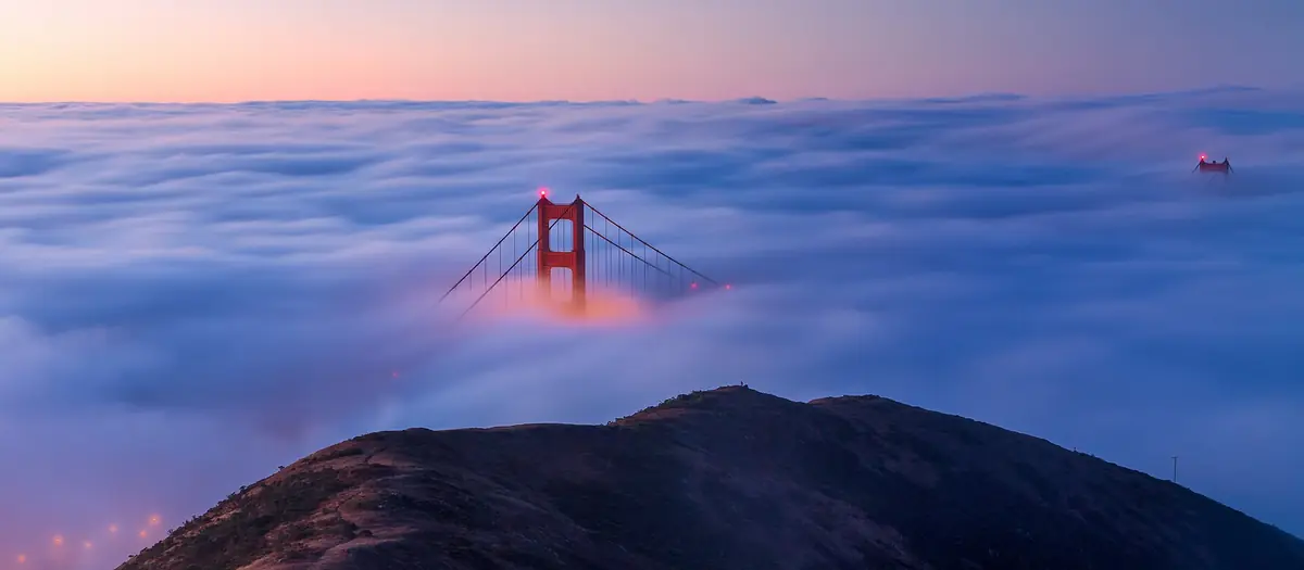 Golden Gate Bridge in fog over San Francisco Bay