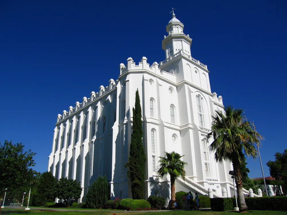 The white St. George Temple against a deep blue sky