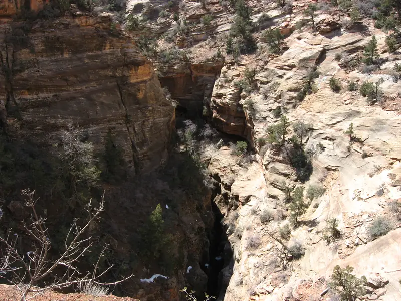 A desert canyon trail winding between rock walls