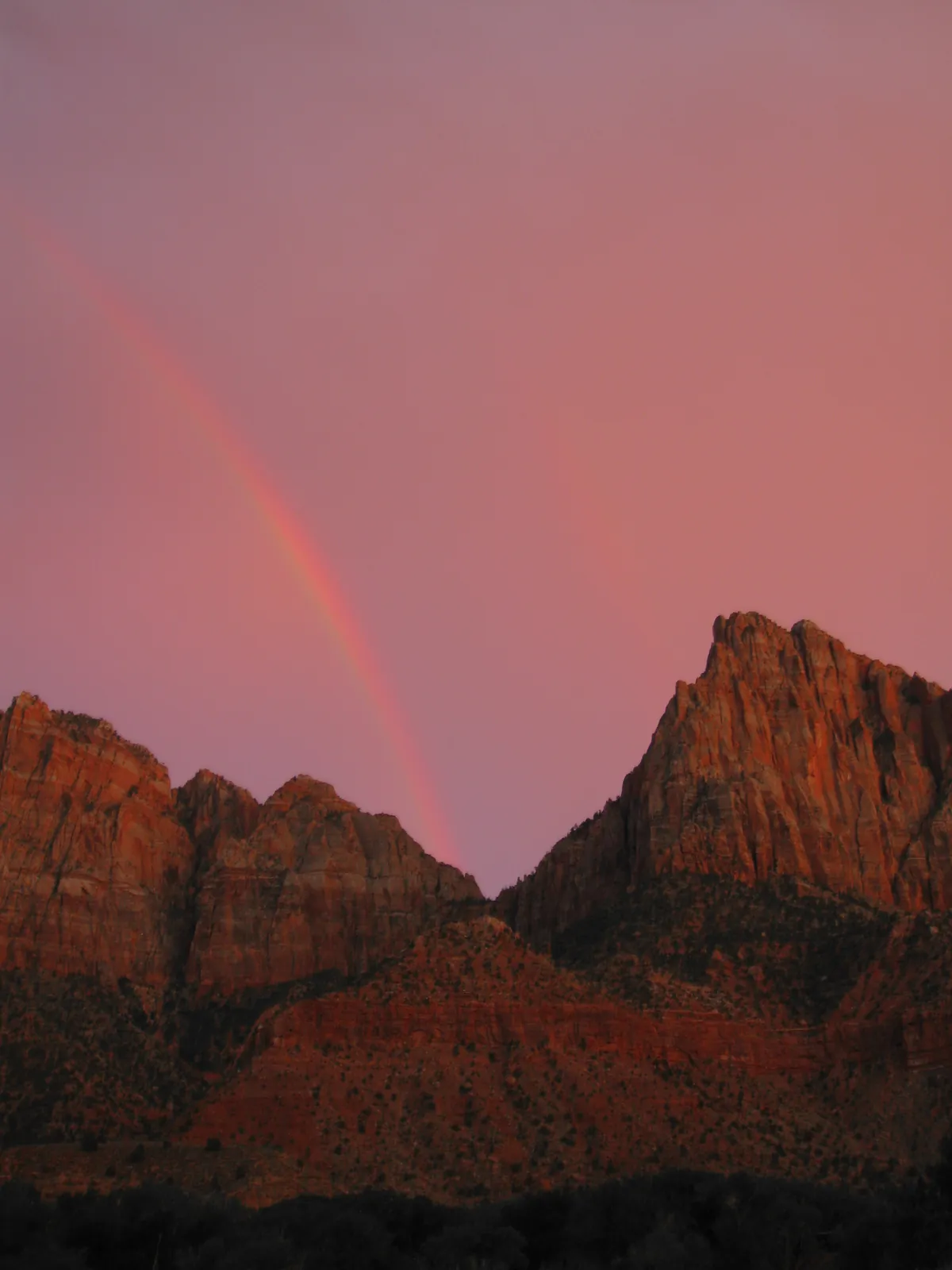 The Watchman glowing under a storm-washed desert sky