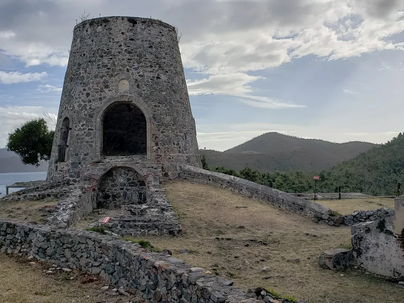 The stone windmill tower of the Annaberg plantation ruins above the sea