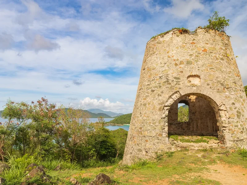 The stone ruin of the Peace Hill windmill on a grassy hilltop on St. John