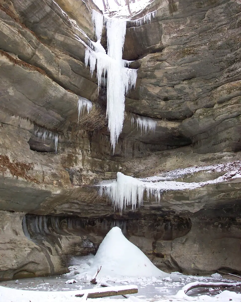 Photo: the waterfall at the head of St. Louis Canyon, Starved Rock State Park, between layered sandstone walls.