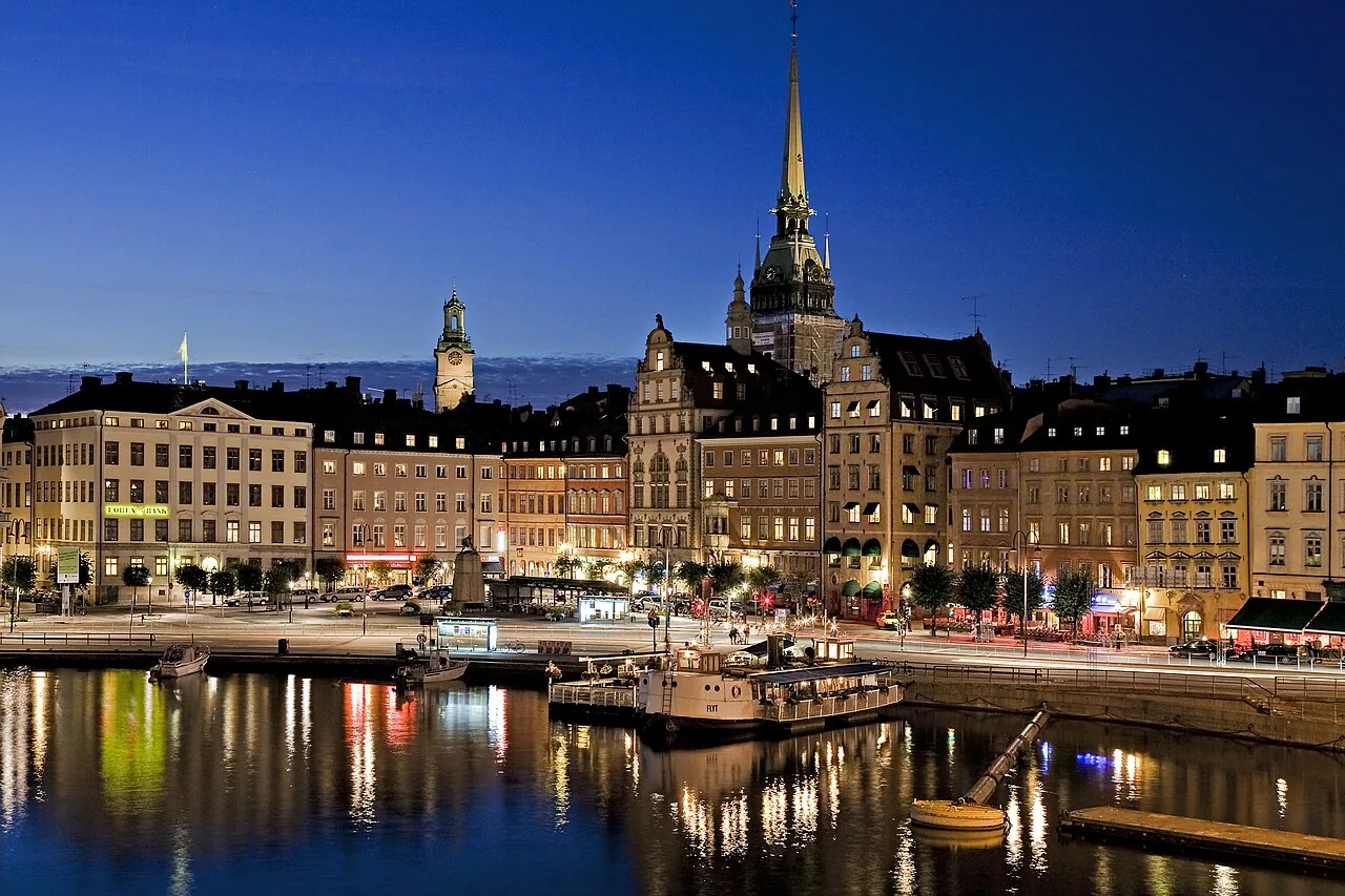 Gamla Stan's waterfront at dusk, Stockholm — warm lights reflecting on the water