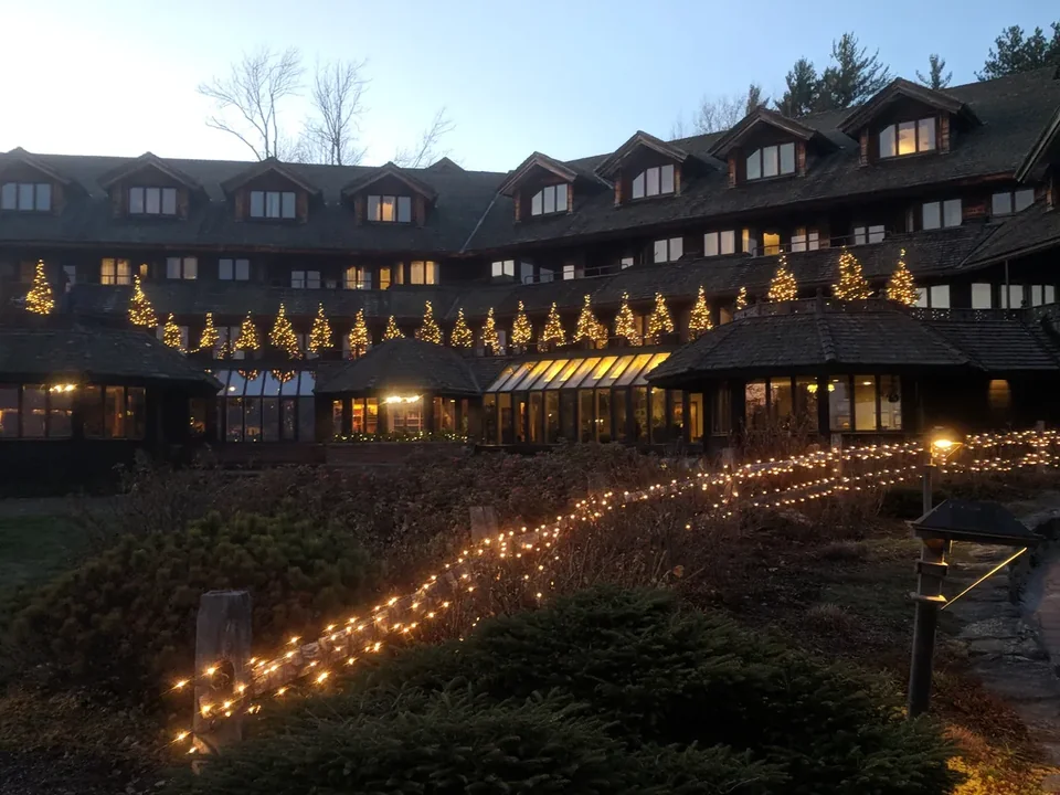 The Trapp Family Lodge at night with its balconies lit and strings of lights along the path