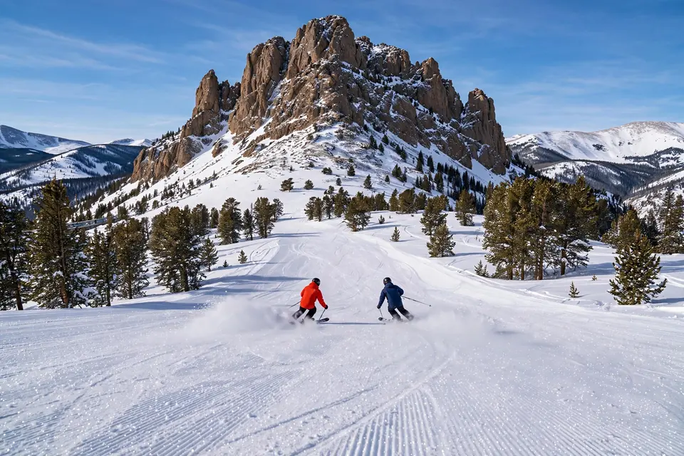 Skiers on a powder slope beneath Kachina Peak at Taos Ski Valley