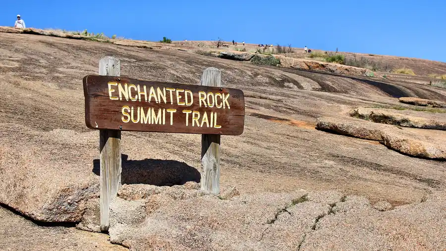 Summit Trail sign on the pink granite dome of Enchanted Rock