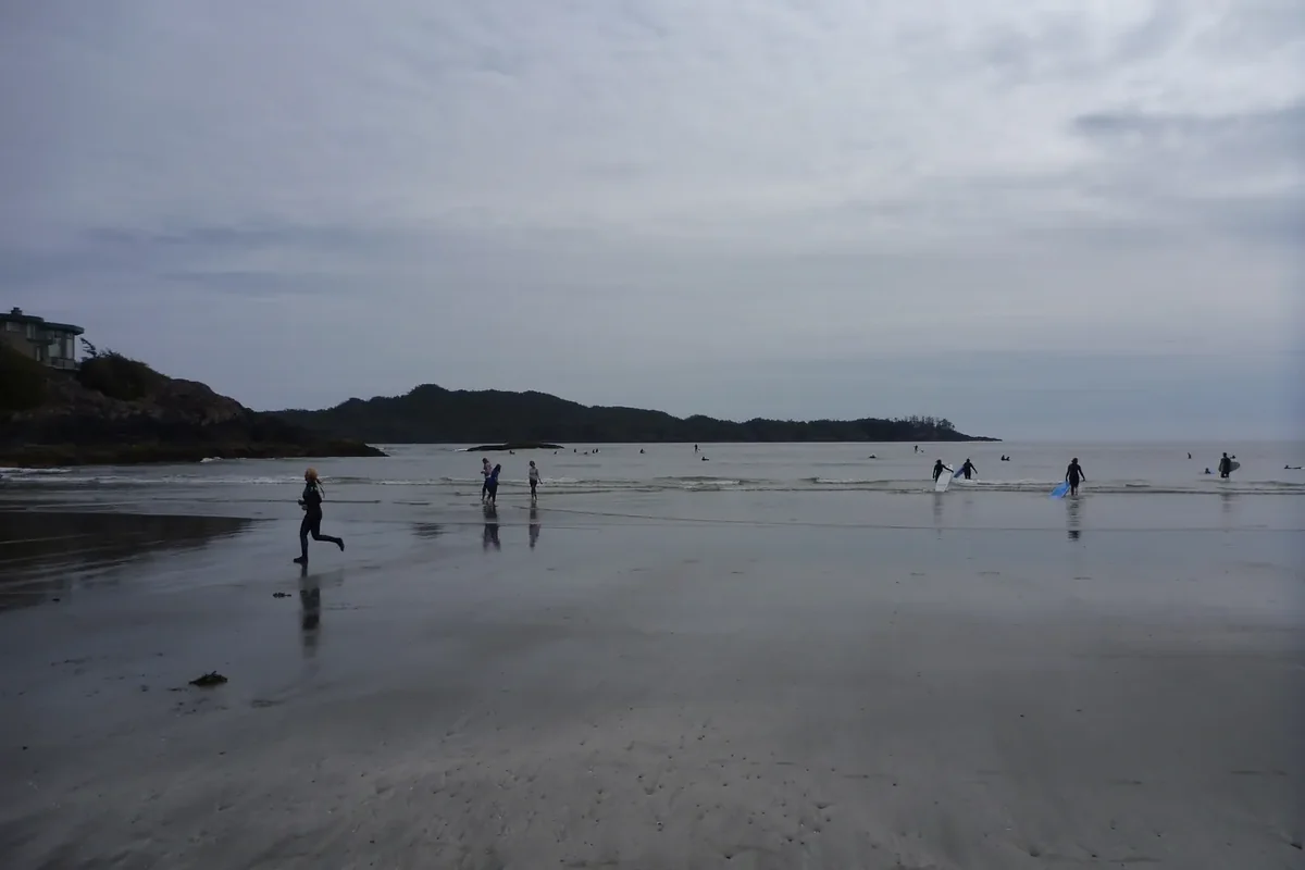 Chesterman Beach in Tofino, a wide sandy beach with forested headlands and Pacific surf