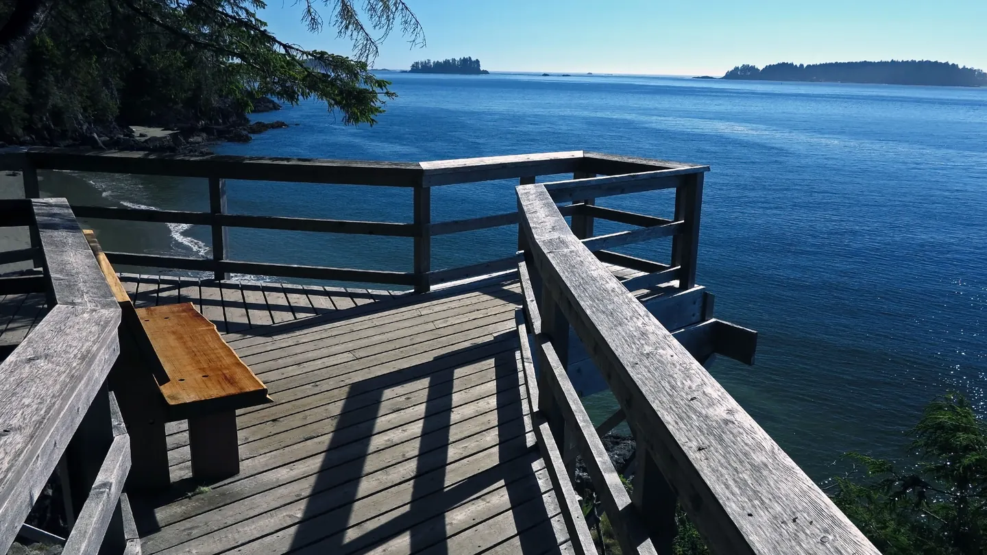 A wooden lookout deck with a bench above the sea near Tonquin Beach, Tofino