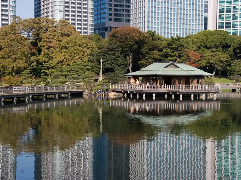 The Nakajima-no-ochaya teahouse on an island in the pond at Hama-rikyu Gardens, with Shiodome towers behind