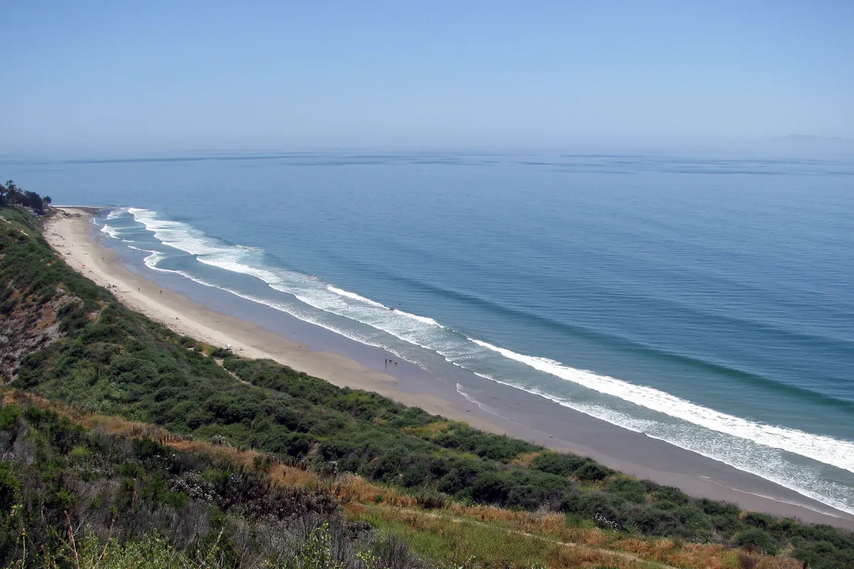 Lines of swell wrapping around Rincon Point on the coast at the Ventura and Santa Barbara county line