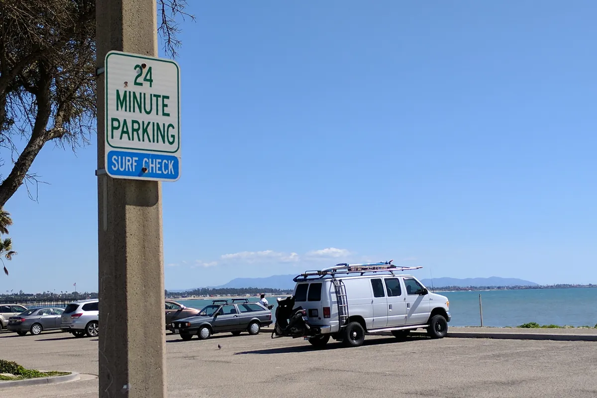 A surf check parking sign at the lot above Surfers Point in Ventura