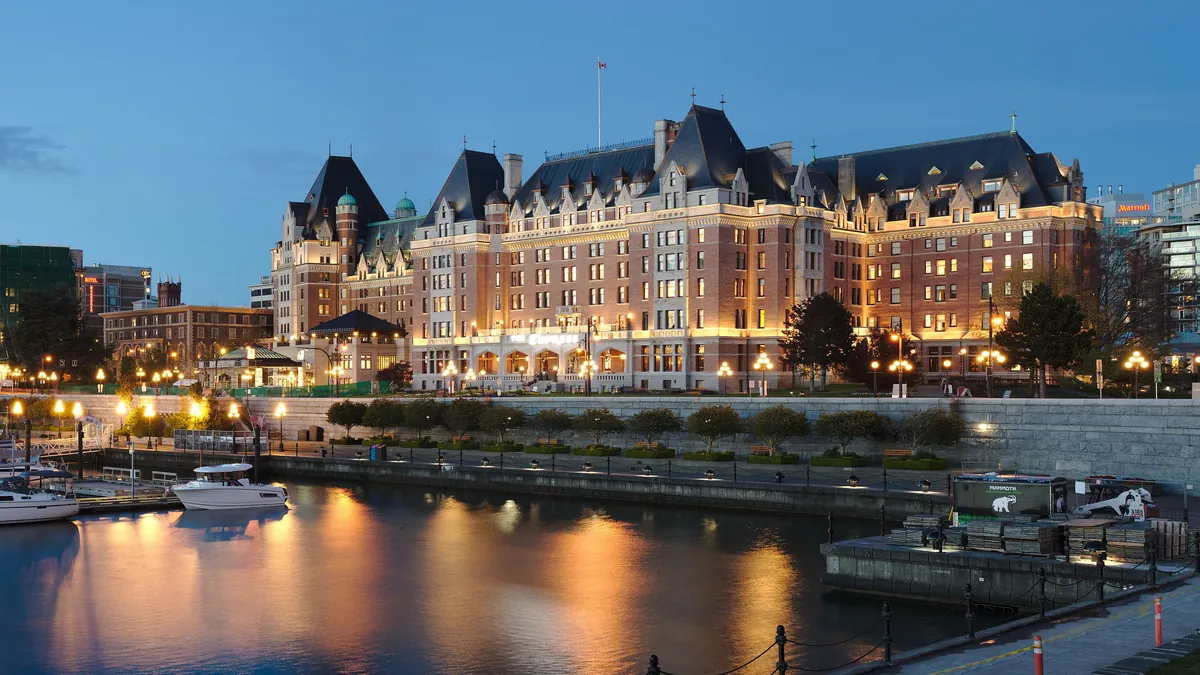 The Fairmont Empress hotel lit at blue hour across the Inner Harbour in Victoria, BC