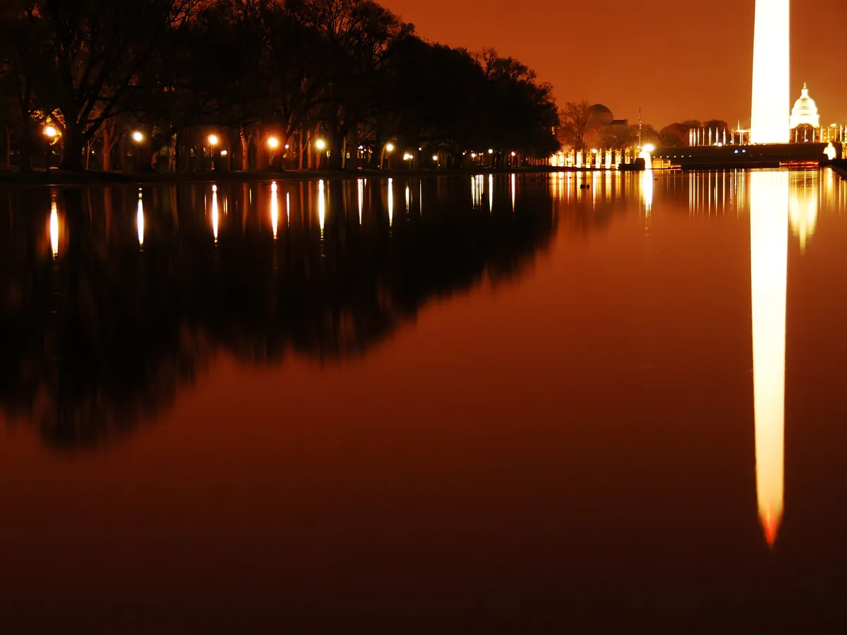 The Reflecting Pool at night with the lit Washington Monument reflected in the water