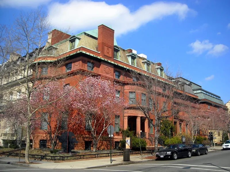 The red-brick Phillips Collection building on a corner near Dupont Circle with trees in bloom