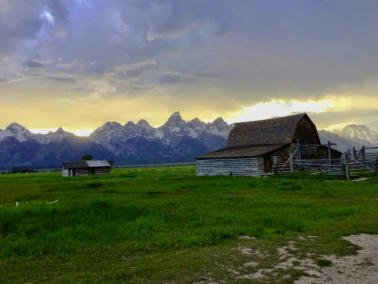 Mormon Row barns with Tetons at sunset